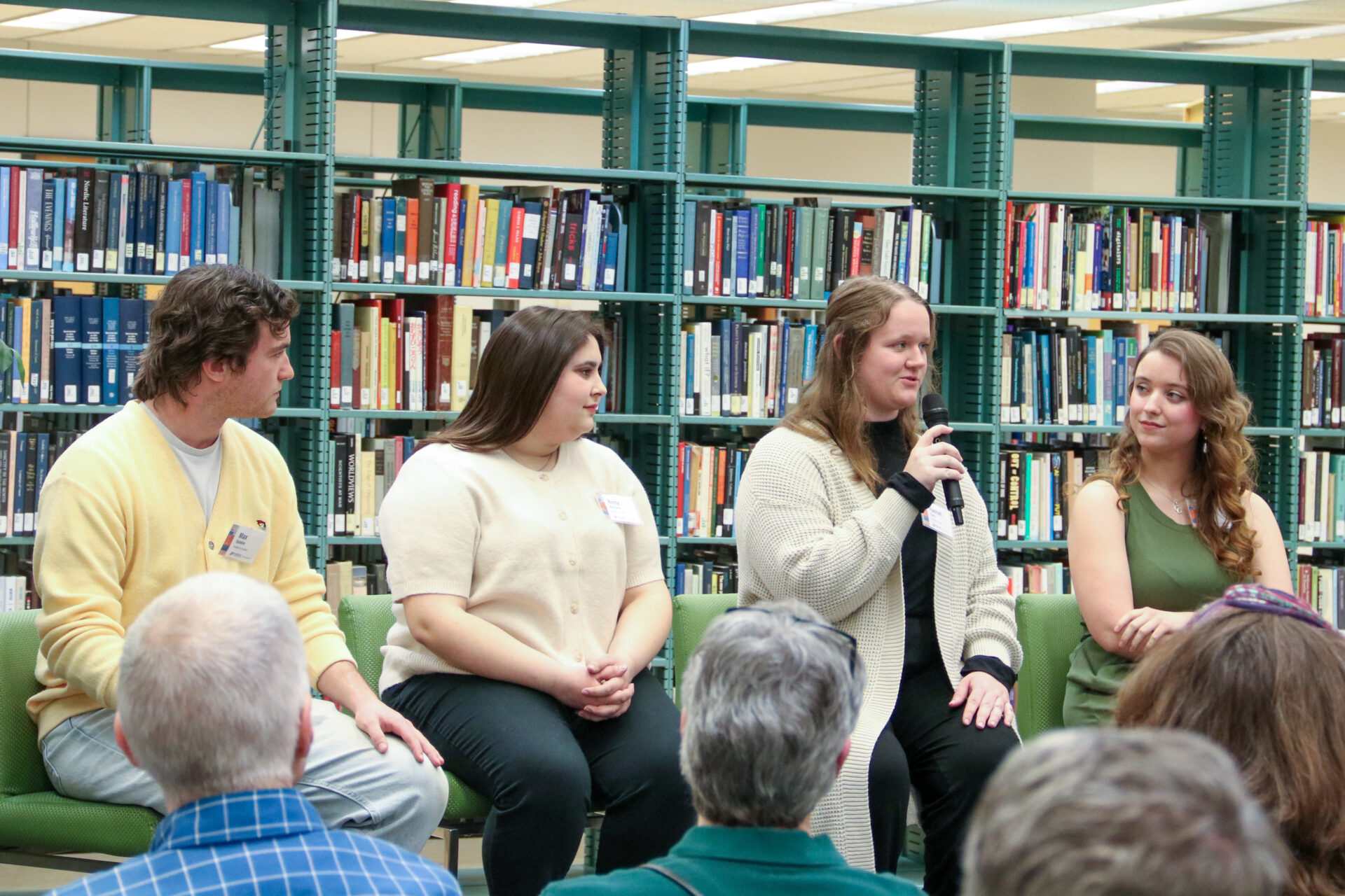 Four students speaking on a panel