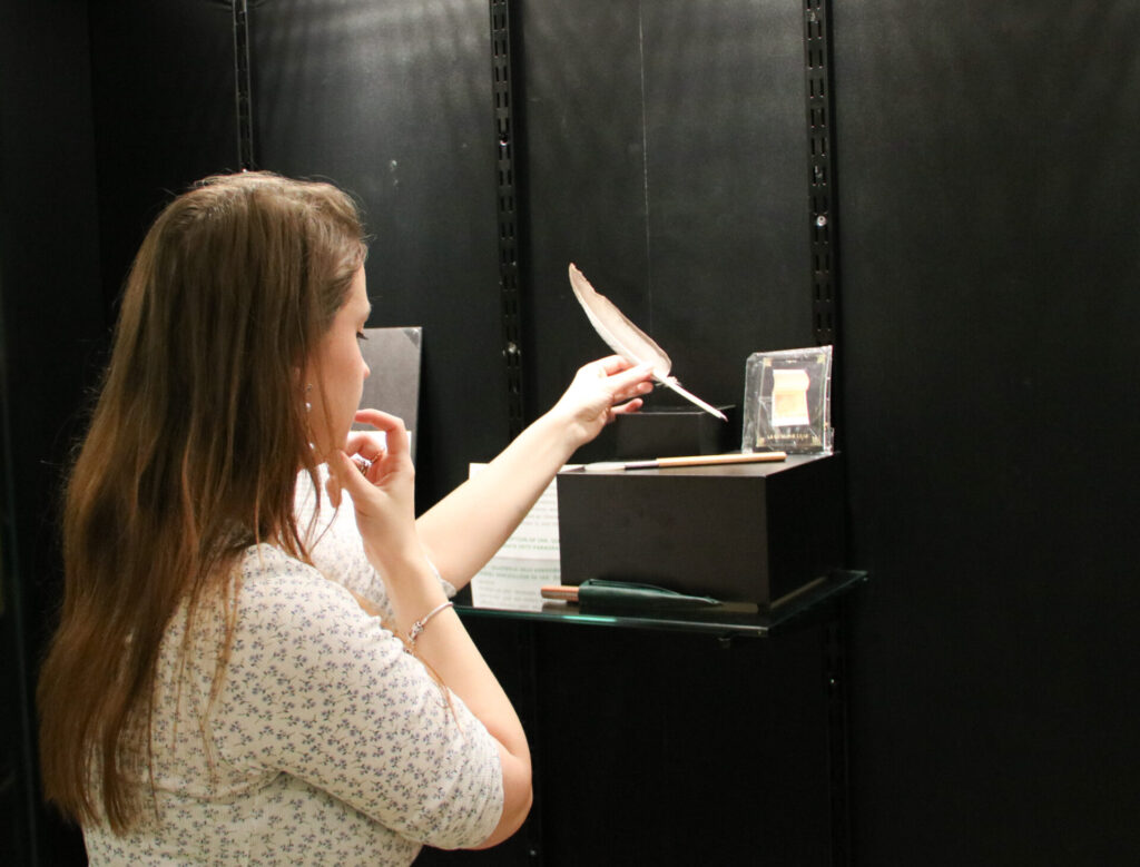 A student placing archival material into a display case